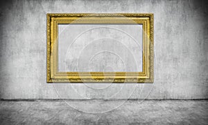 Old golden frame on gray wall