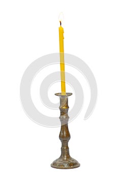 Old golden holder with yellow candle