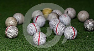 Old golf balls on artificial grass