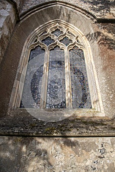 Old gothic arched carved leaded window
