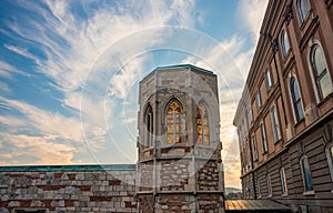 Old gothic tower of Buda Castle with colorful stained glass against picturesque sky. Budapest, Hungary