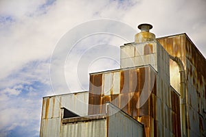 Old grain mill with rusty siding