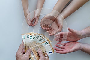 Old grandfather or grandmother hands giving 50 euros banknotes to another pairs of hands of his her wife man and