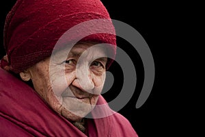 Old grandma in red headscarf with piercing look