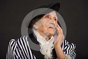 Old grandma in a white-black striped jacket