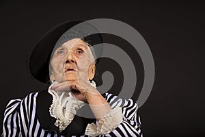 Old grandma in a white-black striped jacket