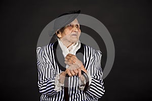 Old grandma in a white-black striped jacket