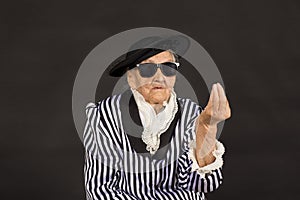 Old grandma in a white-black striped jacket