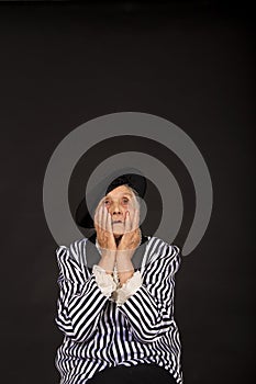 Old grandma in a white-black striped jacket photo