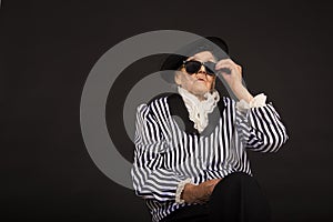 Old grandma in a white-black striped jacket photo