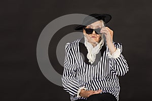 Old grandma in a white-black striped jacket photo