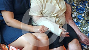 An old grandmother with a daughter and an adult granddaughter, close-up of hands