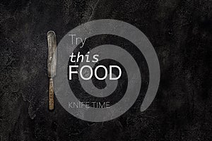 Old grange knife on concrete with text try this food top view