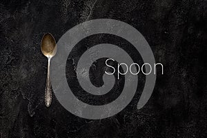 Old grange spoon with spoon on concrete top view
