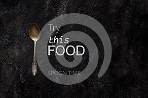 Old grange spoon with text try this food on concrete top view