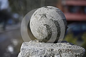 old granite ball covered with moss