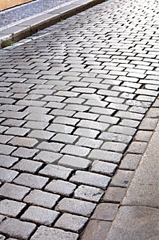 Old granite cobblestone pavement in city