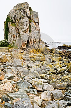 Old granite rock on coast of La Manche