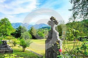 Old grave in cemetery. Orthodox cross tomb stone in graveyard, Europe.