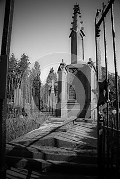 Old grave monument with fence in the sun