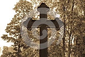 Old graveyard cross on the abandoned cemetery.