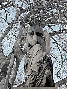 An Old Graveyard Statue During Winter