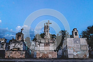 Old graveyard tombs with crosses and angel statue at the cemetery `Cementerio General` in Merida, Yucatan, Mexico photo