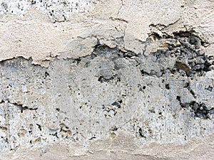 Old gray brick wall covered with concrete. Abstract background