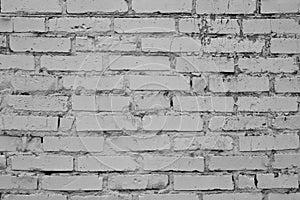 Old gray cracked brick wall. Vintage brick texture. Brick wall background. Vintage house facade. Old concrete grunge texture. Inte