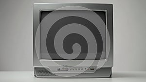 Old gray CRT TV shows interference and static noise, switching channels, turning off, on a light gray background. Empty broadcast