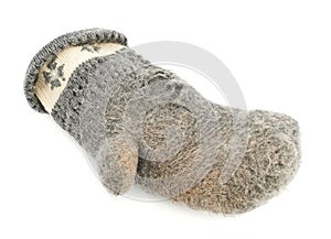 Old gray frayed mitten isolated