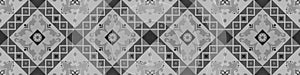 Old gray grey black dark anthracite vintage shabby patchwork mosaic tiles stone concrete cement wall texture background banner,