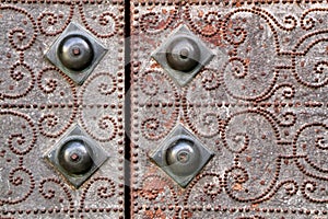 Gray metal door with wrought iron details