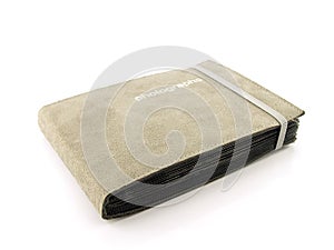 Old gray suede leather photo album with strap isolated on white background