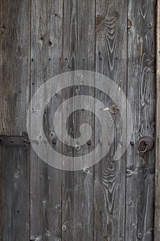 Old gray threadbare wooden door in an old house