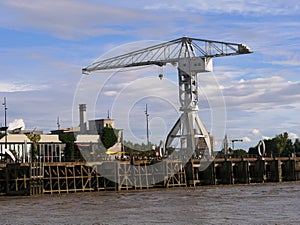 Old gray Titan construction crane and the Buren rings on the banks of the Loire in Nantes