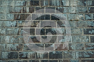 Old gray vintage weathered brick wall texture of ancient castle. Grunge rough block stonewall, masonry structure surface pattern