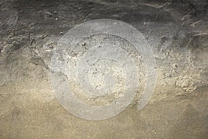 An old gray white black shabby concrete wall with severe damage and scratches. rough surface texture