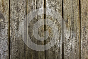 A old gray wooden fence boards. vertical lines. natural surface texture