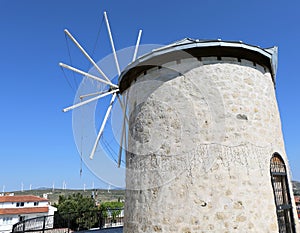 Old Greek Windmill against to New Wind Turbines