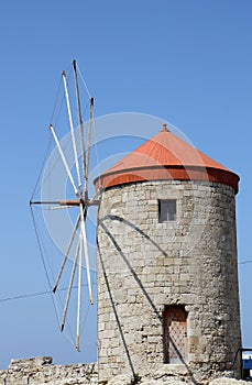 Old Greek Windmill with Red Rooftop by The Port in Rhodes, Greece