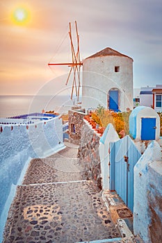 Old greek windmill on Santorini island in Oia town with stairs in street. Santorini, Greece