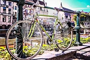 Old green bike alongside the Meuse river, Ghent, Belgium