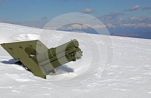 Old green cannon of first World War under the whiite snow photo