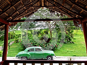 Old green car in the outside of Cuba