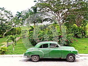Old green car in the outside of Cuba