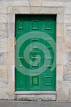 Old green door in a stone wall