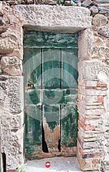 Old green door in stone wall.