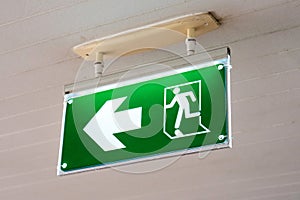 Old Green fire exit sign at hotel.