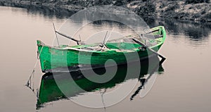 Old green fishing boat on black and white background